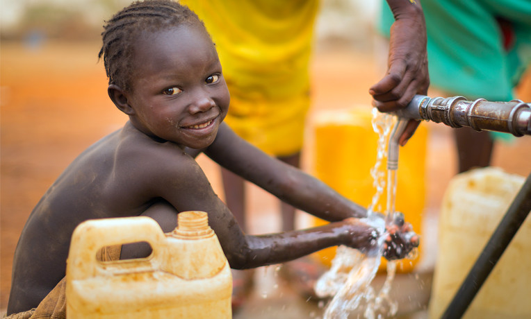 Picture of child drinking water from well